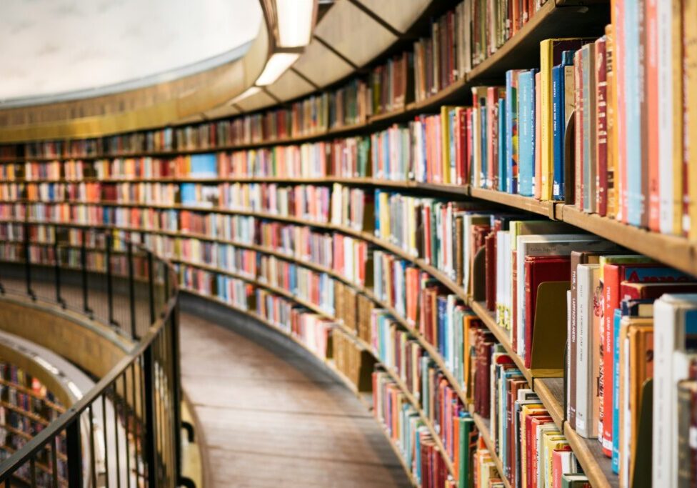 Curved library shelves filled with colorful books.